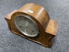 A 1930's walnut cased continental mantel clock with pendulum and key