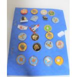 A collection of enamelled metal badges