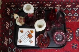 A tray of Victorian and later cranberry glass,