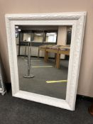 A painted white traditional style mirror,