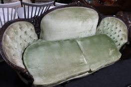 An Edwardian carved mahogany framed three seater shaped back settee