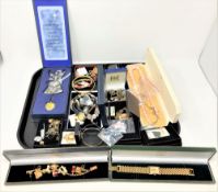 A tray of costume jewellery, gilt wristwatch with faux gold ingot dial, charm bracelet,