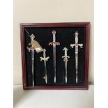 A set of five miniature German daggers mounted in a frame