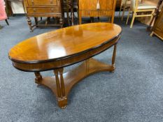 A reproduction inlaid mahogany oval occasional table
