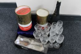 A tray of cut crystal glass, bottle of Cava,