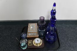 A tray of blue cut crystal decanters, inlaid wooden cigarette dispenser,