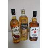 Three bottles of whisky - Jim Beam 1l, High commissioner 70cl and Bushmills Irish Honey 1l.