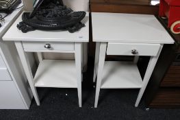 A pair of white bedside stands