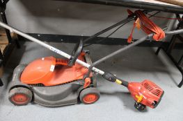 A Flymo lawn mower and a part petrol strimmer