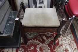 An Edwardian mahogany piano stool with sheet music