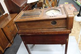 An Edwardian wall clock and sewing trolley