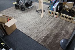 A contemporary deep pile two tone brown carpet