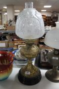 A Victorian brass and glass oil lamp