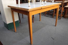 A mid century Formica topped extending kitchen table.