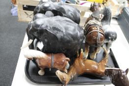 A tray of ebony elephant ornaments,