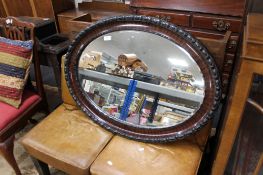 An Edwardian bevelled oval mirror
