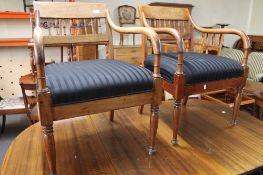A pair of mahogany armchairs in black striped fabric.