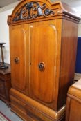 An early 20th century oak double door cabinet fitted with two drawers.