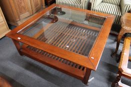 A reproduction pine glass topped coffee table.