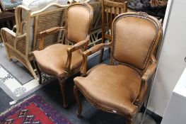 A pair of carved walnut armchairs