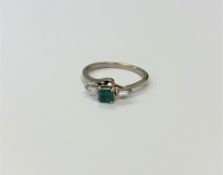 An 18ct gold emerald and diamond ring