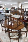 A good quality reproduction oak dining room suite comprising of drop leaf table,