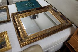 An antique style gilt bevelled mirror