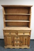 A rustic pine kitchen dresser CONDITION REPORT: 117cm wide by 54cm deep by 181cm