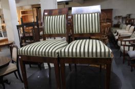 A pair of inlaid mahogany green striped chairs.