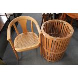 A circular wooden waste bin and a beech framed armchair