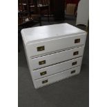 A white painted four drawer chest with brass handles