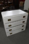 A white painted four drawer chest with brass handles