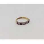 A ruby and diamond half eternity ring, 18CT size O.