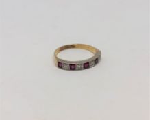 A ruby and diamond half eternity ring, 18CT size O.