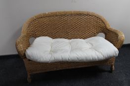 A wicker conservatory settee
