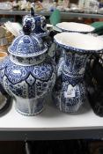 Six items of blue and white Delft ware including lidded urns,