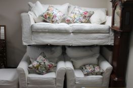 A contemporary three seater settee with pair of matching armchairs,