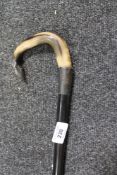 A white metal mounted horn walking stick