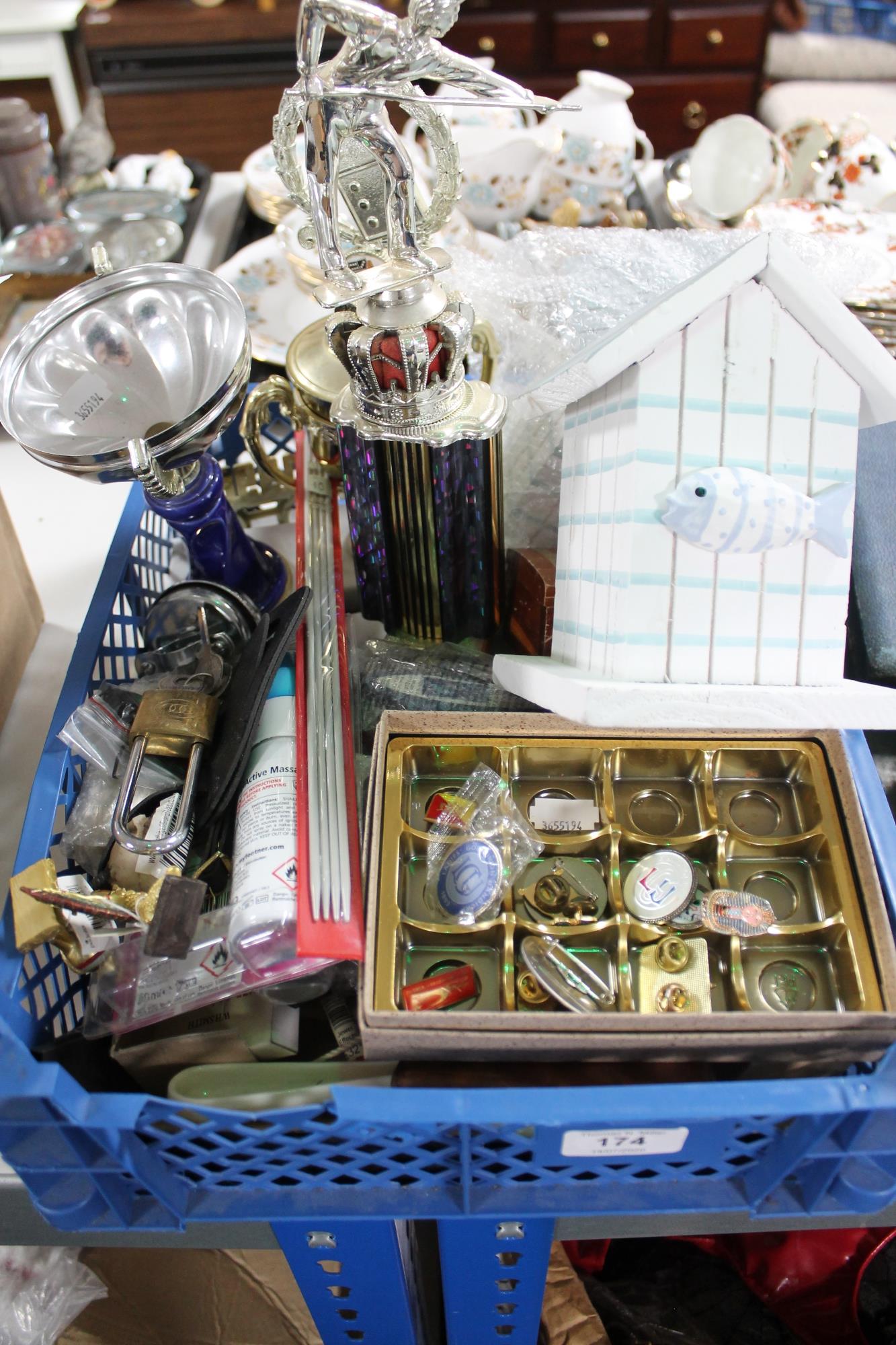 A crate containing sporting trophies, badges,