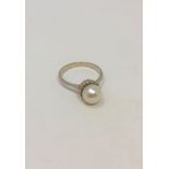An 18ct white gold pearl set ring, size O/P. CONDITION REPORT: 4.0g.