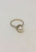 An 18ct white gold pearl set ring, size O/P. CONDITION REPORT: 4.0g.