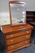 A contemporary three drawer chest and matching mirror
