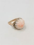 An unusual gold and coral ring, size M. CONDITION REPORT: 10.6g gross.