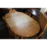 A light oak extending dining room table and six chairs.