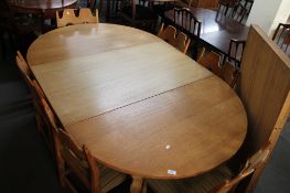 A light oak extending dining room table and six chairs.