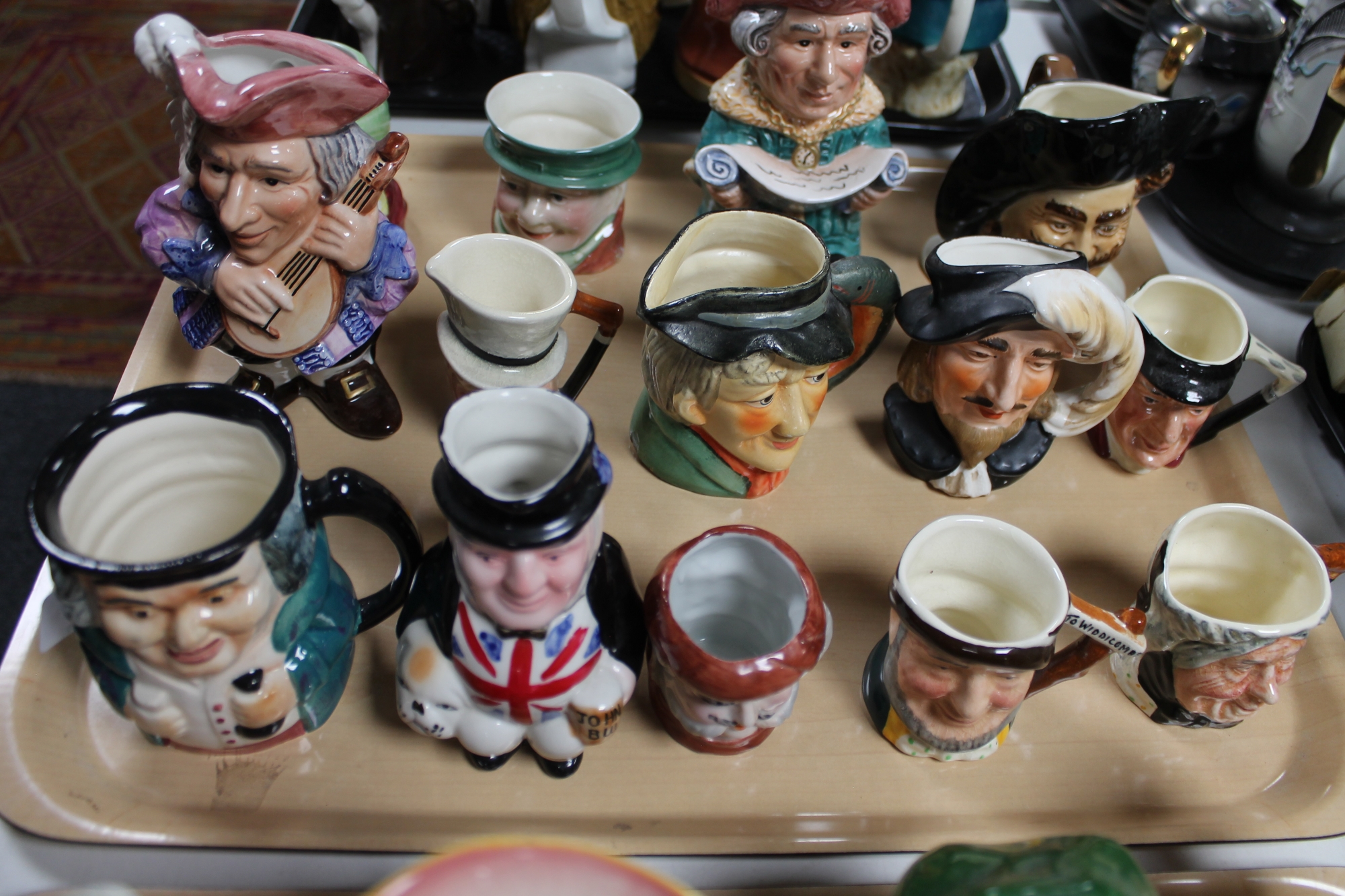 A tray of fourteen ceramic character jugs (14)