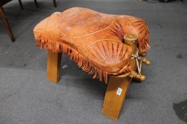 A leather and wooden camel stool