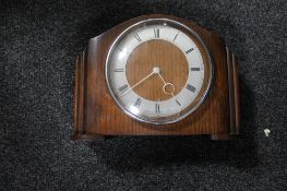 An early 20th century oak mantel clock