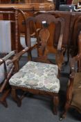 A 19th century oak armchair in floral fabric.