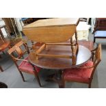 An antique mahogany oval table and a pair of inlaid mahogany armchairs